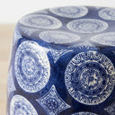 Blue and white ceramic stool  top with intricate medallion pattern.