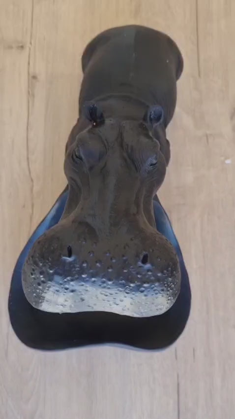 Tabletop display of hippo candy bowl styled with keys and wallet