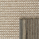 Close-up of the Pridelands outdoor rug showing the beige woven texture of recycled PET and polypropylene fibres.
