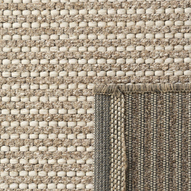 Close-up of the Pridelands outdoor rug showing the beige woven texture of recycled PET and polypropylene fibres.