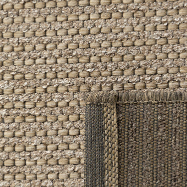 Close-up of the Pridelands outdoor rug showing the brown woven texture of recycled PET and polypropylene fibres.