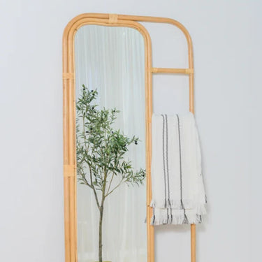 rattan mirror with ladder rungs for hanging towels and blankets