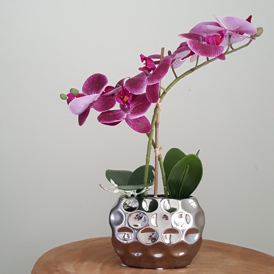 artificial purple orchid in silver pot