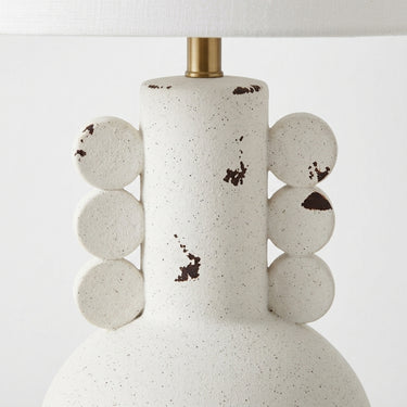 table lamp neck with a off-white ceramic body, dark brown speckled distressing, and a brass finished neck fitting.