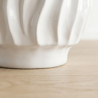 Ripple side table  base with wavy ridged texture in glossy white ceramic.