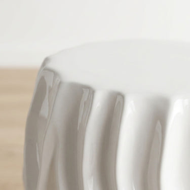 Ripple side table  top edge with wavy ridged texture in glossy white ceramic.