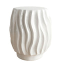 Ripple side table with wavy ridged texture in glossy white ceramic.
