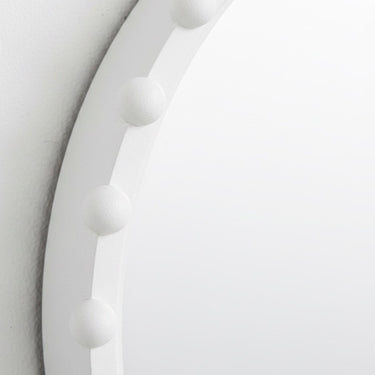 Close-up of beaded detail on round wall mirror
