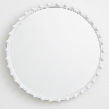 White round mirror with beads styled on wall