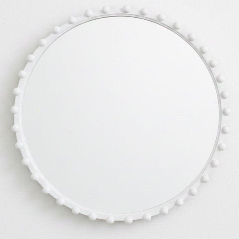 White round mirror with beads styled on wall