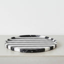 Round black marble vanity tray in black and white striped marble