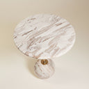 Top view of the round marble side table showing cream and brown veining