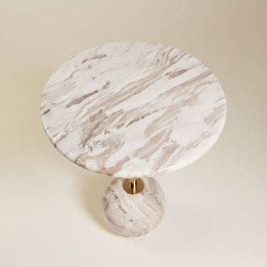 Top view of the round marble side table showing cream and brown veining