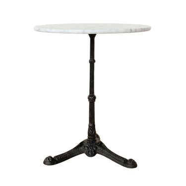 Round white marble bistro table with an ornate black cast iron pedestal base.