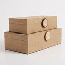 Raffia storage box set with wood knob lids in natural tone.