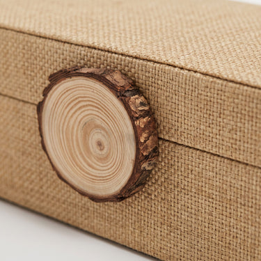 Raffia storage box wood knob on lid in natural tone.