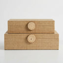 Two stacked rectangular storage boxes with woven natural-fiber texture and round wooden knobs.