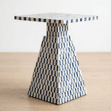 Santorini capiz side table  with square top with a checkered blue and pearl pyramid pedestal base.