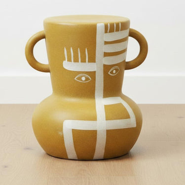Sculptural accent stool styled on wooden floor