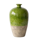 A ceramic vase with a glossy green upper body and a textured, earthy beige lower half, shown against a plain white background.