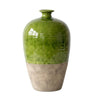 A ceramic vase with a glossy green upper body and a textured, earthy beige lower half, shown against a plain white background.