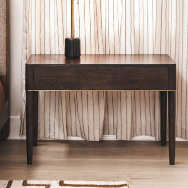 sienna wooden large nightstand or side table against a neutral curtain in bedroom