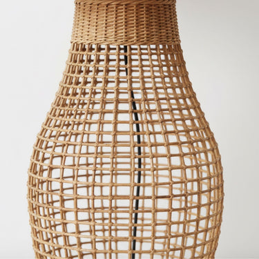 Detailed view of the sol minimalist lamp hand-woven rattan cane craftsmanship and airy open-weave sculptural silhouette