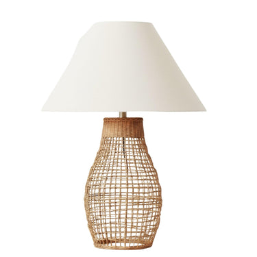 Sol natural rattan table lamp featuring an open-weave base and a crisp beige fabric shade by Woodka Interiors