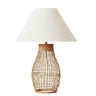 Sol natural rattan table lamp featuring an open-weave base and a crisp beige fabric shade by Woodka Interiors