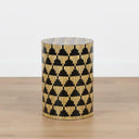 Sculptural mother of pearl side table styled as a standalone focal point in a bright, minimalist room.