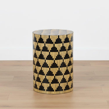 Sculptural mother of pearl side table styled as a standalone focal point in a bright, minimalist room.