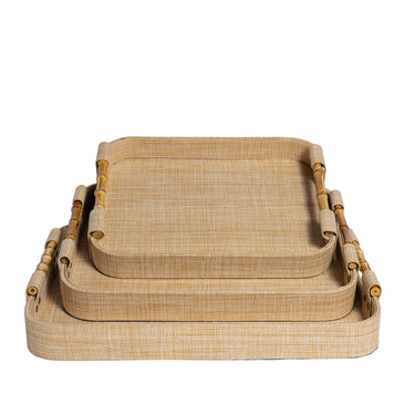 Set of 3 natural tan nesting rectangle raffia trays with bamboo handles.