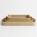 Three nested rectangular woven trays in a natural tan color, featuring rolled bamboo handles on the sides.