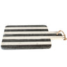 Black and white striped cutting board with a handle 