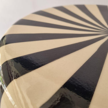Close-up of the Striped Ceramic Side Table – Black showing the glossy ceramic finish