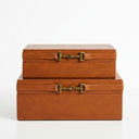 Two stacked rectangular  PU leather storage boxes in a warm tan-brown colour with a brass horsebit-style clasp closure.