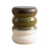 Terra Stool, a modern stacked ceramic stool with four rounded tiers in a glossy glaze — dark brown top, olive green middle, white bottom.
