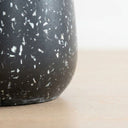 Terrazzo black side table  base with speckle detail.