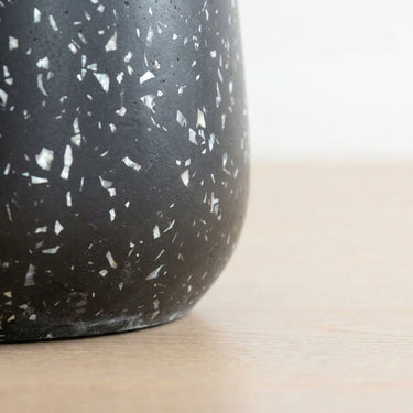 Terrazzo black side table  base with speckle detail.