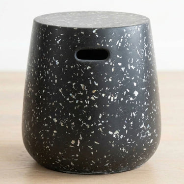 Terrazzo black side table with speckle detail and cut-out handles.