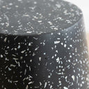 Terrazzo black side table with speckle detail.
