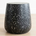Terrazzo black side table with speckle detail and cut-out handles.