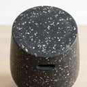 Terrazzo black side table top with speckle detail and cut-out handles.
