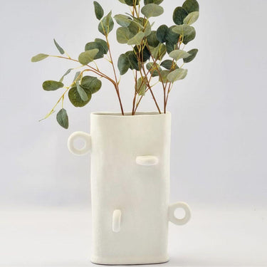 Textured ceramic vase styled with eucalyptus stems for home decor