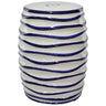 Glossy white ceramic stool with wavy raised navy blue lines and a subtle cut-out on top