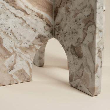 Toronto marble side table top showing warm white and brown veining on arch-panel base