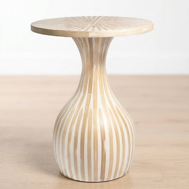 Tulum Side Table with a flared pedestal base, featuring a light natural top and a bulbous base with alternating vertical beige and white stripes, set against a neutral light background.