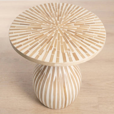 top view of tulum round side table with a sunburst inlay pattern top and bulbous pedestal base.