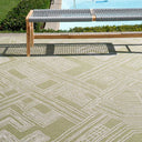 Urban Moss Rug styled poolside with a wooden bench