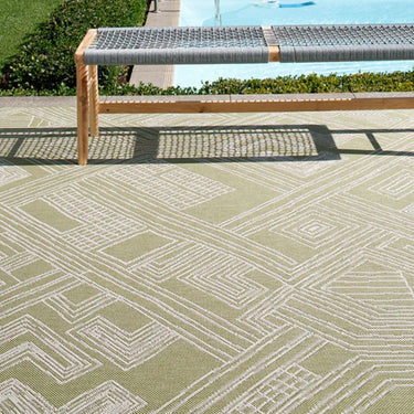 Urban Moss Rug styled poolside with a wooden bench